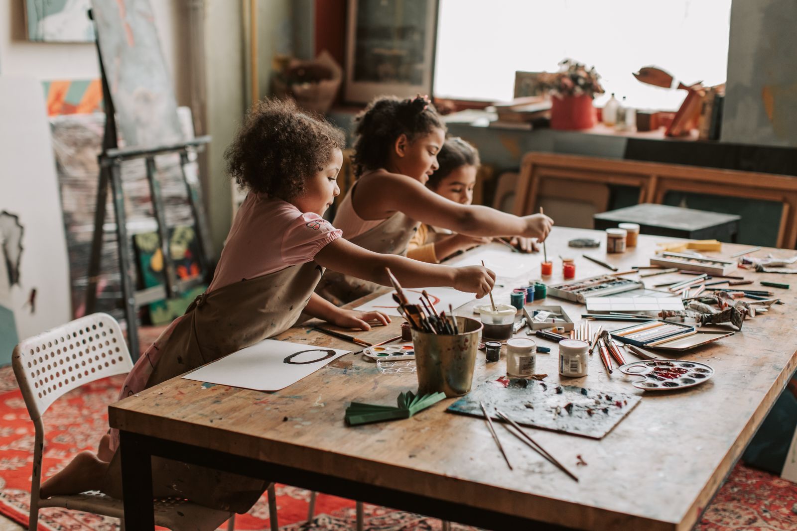 Children working at a Pearl Quest art table